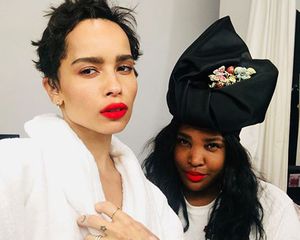 Zoe Kravitz in white robe with her hair stylist
