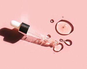 oil dropper on pink background