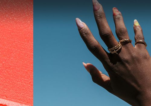 collage of a smeared makeup and an image of two hands with painted fingernails