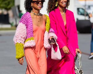 Two women walking wearing slip dresses.