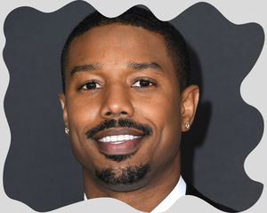 Close up of the actor Michael B. Jordan, wearing a thin mustache.