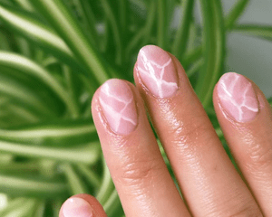 Close up of a neutral-colored jade manicure