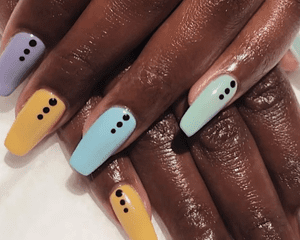 woman with dotted short coffin nails manicure